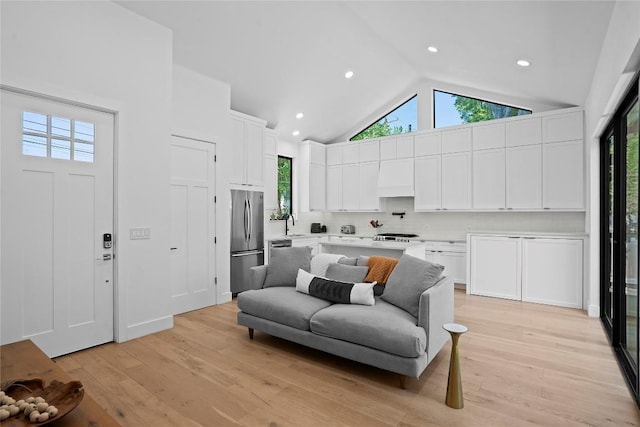 2216 Lindell Ave Unit 2, Austin, TX 78704 - living room with healthy amount of natural light, high vaulted ceiling, light wood-type flooring, and recessed lighting