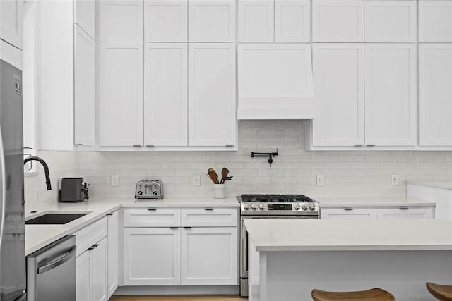 2216 Lindell Ave Unit 2, Austin, TX 78704 - kitchen featuring appliances with stainless steel finishes, tasteful backsplash, light countertops, and white cabinetry