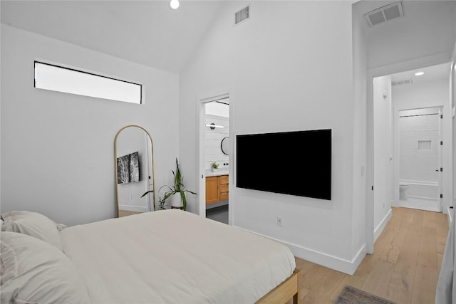 2216 Lindell Ave Unit 2, Austin, TX 78704 - bedroom with high vaulted ceiling, light wood finished floors, recessed lighting, and ensuite bathroom
