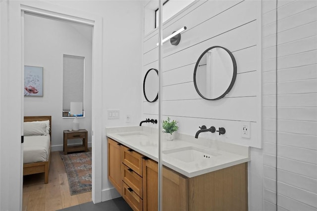 2216 Lindell Ave Unit 2, Austin, TX 78704 - full bath featuring double vanity, wood finished floors, and connected bathroom