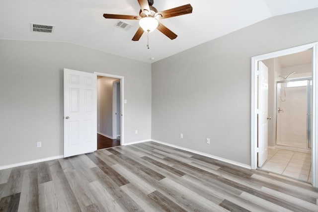 371 Bloomsbury Dr, Kyle, TX 78640 - unfurnished bedroom with lofted ceiling, wood finished floors, ensuite bath, and a ceiling fan