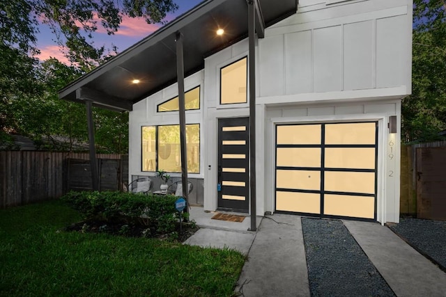 619 Hammack Dr Unit 2, Austin, TX 78752 - view of front of house featuring board and batten siding, a garage, and driveway