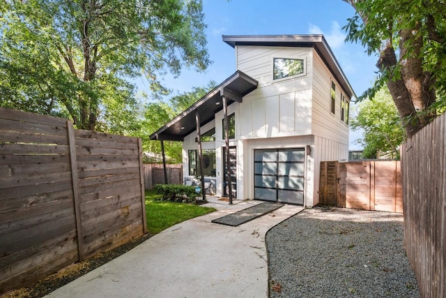 619 Hammack Dr Unit 2, Austin, TX 78752 - view of front facade featuring concrete driveway, a gate, and a garage