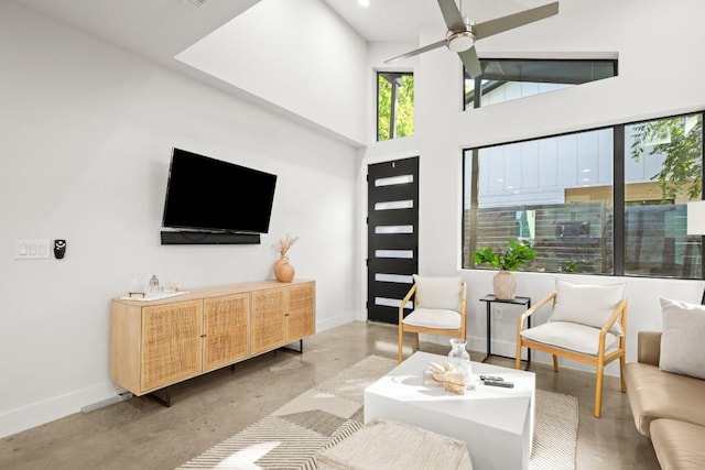 619 Hammack Dr Unit 2, Austin, TX 78752 - living room with finished concrete floors, a ceiling fan, a towering ceiling, and recessed lighting