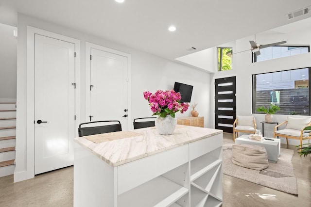 619 Hammack Dr Unit 2, Austin, TX 78752 - kitchen featuring concrete flooring, recessed lighting, light stone counters, a ceiling fan, and open floor plan