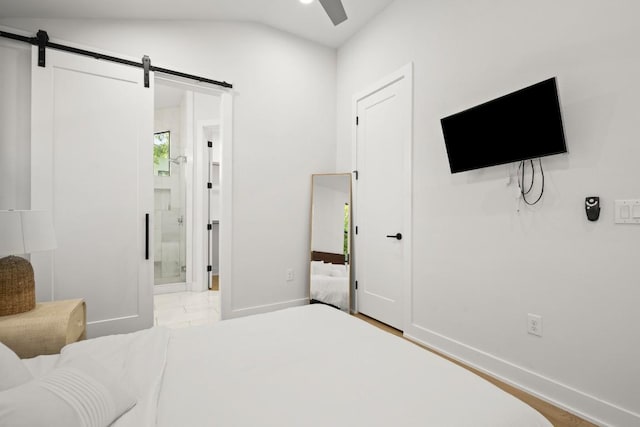 619 Hammack Dr Unit 2, Austin, TX 78752 - bedroom with a barn door, vaulted ceiling, connected bathroom, and ceiling fan