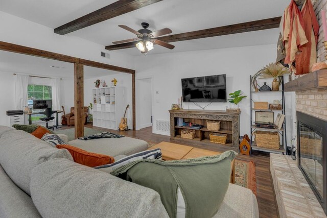 409 White Wing Way, Round Rock, TX 78664 - living room featuring a fireplace, beam ceiling, wood finished floors, and a ceiling fan