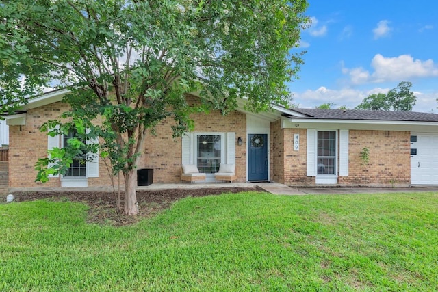 409 White Wing Way, Round Rock, TX 78664 - view of front of property with a garage, brick siding, and a front lawn