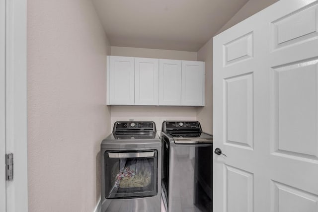 409 White Wing Way, Round Rock, TX 78664 - laundry area featuring cabinet space, washer and dryer, and wood finished floors