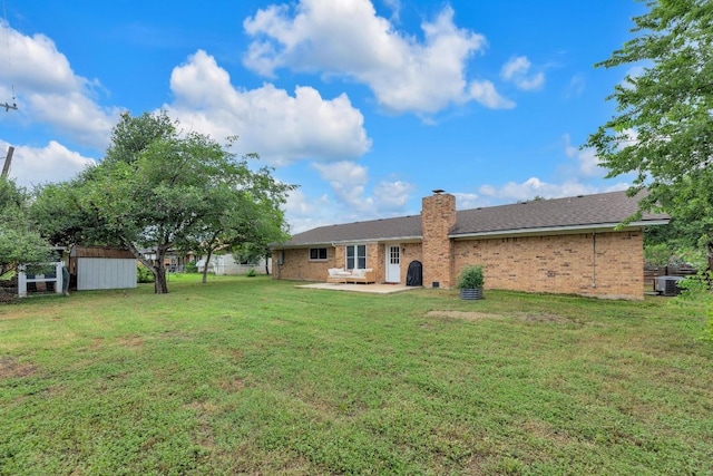 409 White Wing Way, Round Rock, TX 78664 - rear view of property with brick siding, a patio area, a storage shed, and a chimney