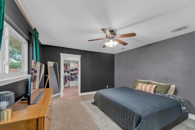 409 White Wing Way, Round Rock, TX 78664 - carpeted bedroom with a walk in closet, ceiling fan, and a closet
