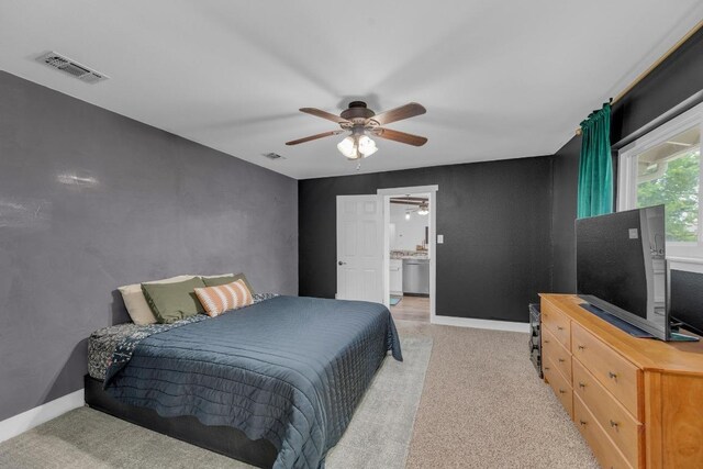 409 White Wing Way, Round Rock, TX 78664 - bedroom with light colored carpet, ceiling fan, and connected bathroom