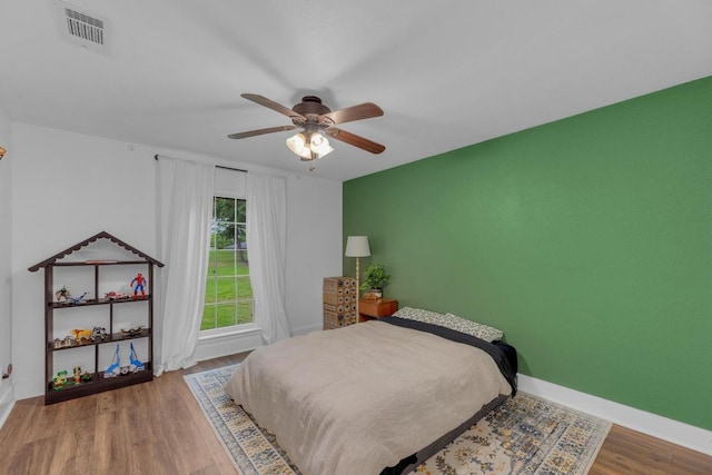 409 White Wing Way, Round Rock, TX 78664 - bedroom with wood finished floors and a ceiling fan