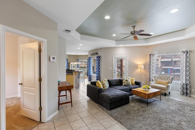 521 Lucy Ln, Horseshoe Bay, TX 78657 - living area with a ceiling fan, plenty of natural light, light tile patterned flooring, recessed lighting, and a raised ceiling