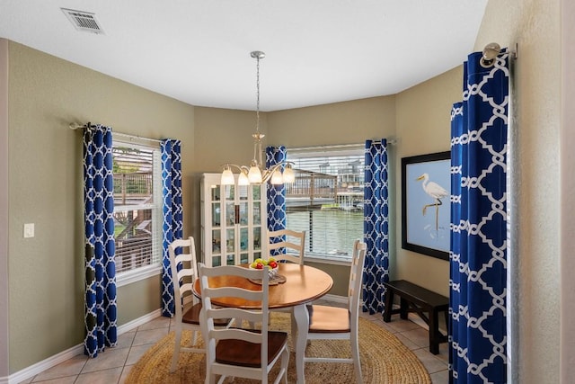 521 Lucy Ln, Horseshoe Bay, TX 78657 - dining space with light tile patterned flooring, plenty of natural light, and a chandelier