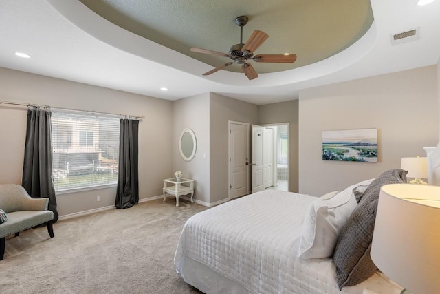 521 Lucy Ln, Horseshoe Bay, TX 78657 - bedroom with carpet floors, recessed lighting, a ceiling fan, a raised ceiling, and connected bathroom