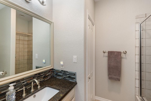521 Lucy Ln, Horseshoe Bay, TX 78657 - bathroom with vanity, backsplash, and tiled shower