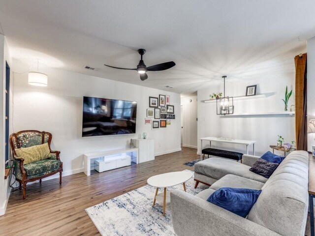 11405 Bristle Oak Trl, Austin, TX 78750 - living room with wood finished floors, a ceiling fan, and a chandelier