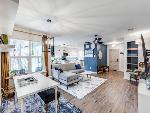 11405 Bristle Oak Trl, Austin, TX 78750 - living area with ceiling fan, light wood-style flooring, and a chandelier