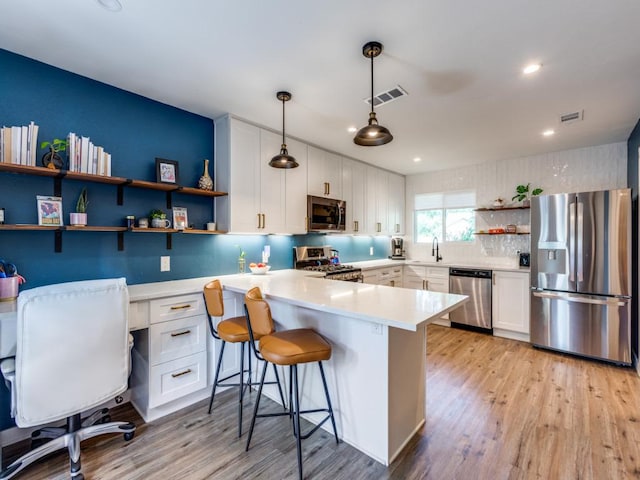 11405 Bristle Oak Trl, Austin, TX 78750 - kitchen with appliances with stainless steel finishes, open shelves, a peninsula, light wood-style flooring, and recessed lighting