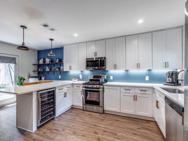 11405 Bristle Oak Trl, Austin, TX 78750 - kitchen featuring beverage cooler, appliances with stainless steel finishes, light countertops, open shelves, and recessed lighting