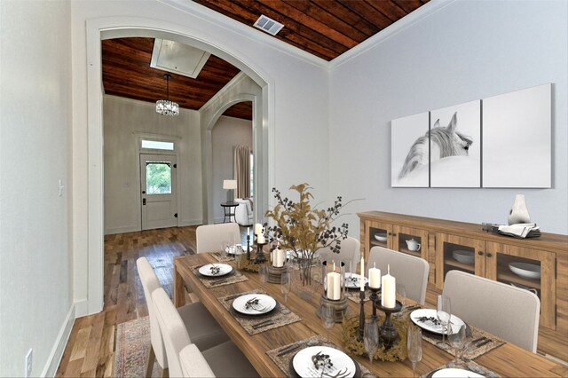 1104 E Salty St, Thorndale, TX 76577 - dining room with wood ceiling, arched walkways, crown molding, and wood finished floors