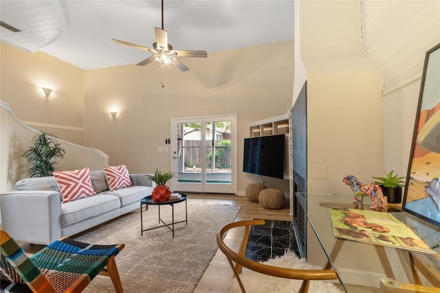 2206 Newfield Ln, Austin, TX 78703 - living room with ceiling fan, wood finished floors, and a high ceiling