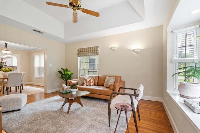 2206 Newfield Ln, Austin, TX 78703 - living area featuring wood finished floors, ceiling fan, and a raised ceiling