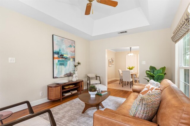 2206 Newfield Ln, Austin, TX 78703 - living room featuring wood finished floors, ceiling fan, and a tray ceiling