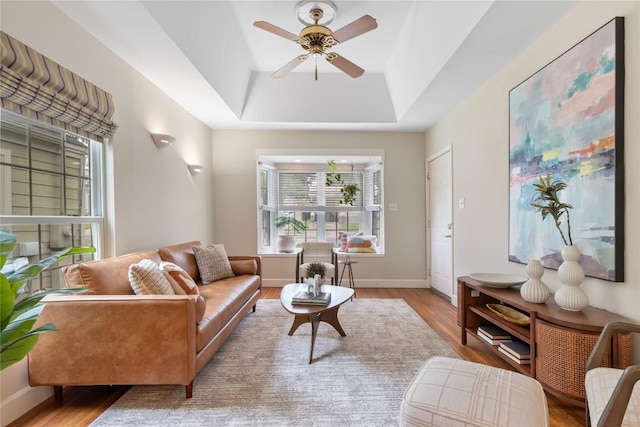 2206 Newfield Ln, Austin, TX 78703 - living room with wood finished floors, a tray ceiling, and ceiling fan