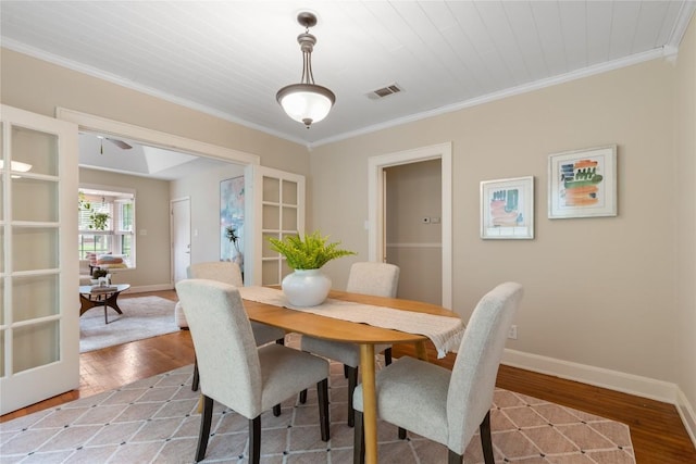 2206 Newfield Ln, Austin, TX 78703 - dining space featuring light wood-type flooring, crown molding, a ceiling fan, and french doors
