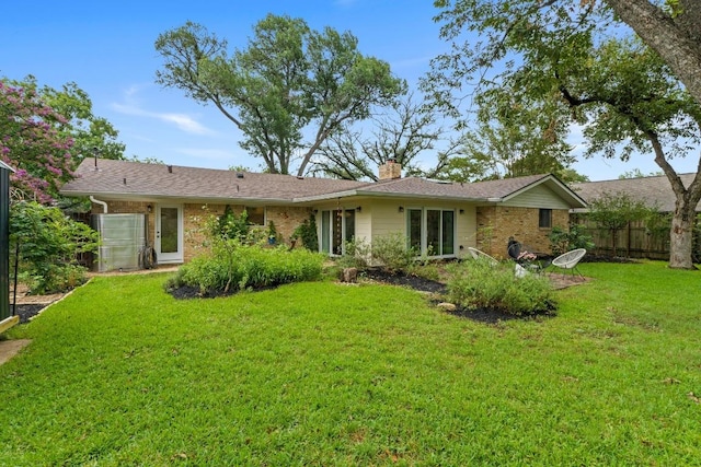 7710 Shoal Creek Blvd, Austin, TX 78757 - rear view of property with a chimney and brick siding