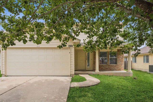 1444 Kenneys Way, Round Rock, TX 78665 - view of front of home with concrete driveway, a front lawn, brick siding, and an attached garage