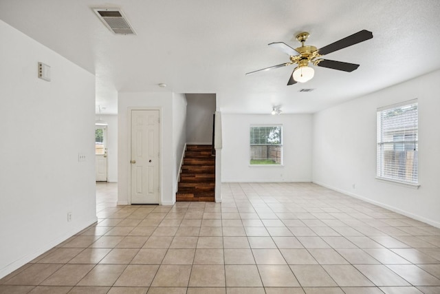 1444 Kenneys Way, Round Rock, TX 78665 - unfurnished room featuring plenty of natural light, ceiling fan, light tile patterned flooring, and stairway