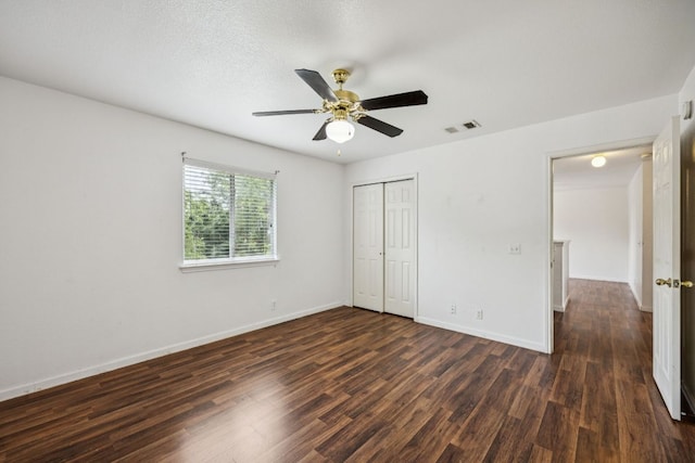 1444 Kenneys Way, Round Rock, TX 78665 - unfurnished bedroom featuring dark wood-style flooring, a closet, and a ceiling fan