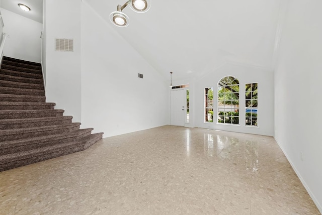 1213 Pathfinder Way, Round Rock, TX 78665 - unfurnished living room featuring high vaulted ceiling and stairway