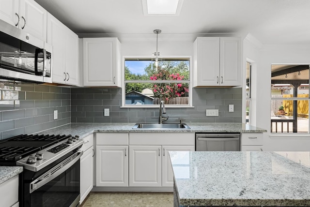 1213 Pathfinder Way, Round Rock, TX 78665 - kitchen with stainless steel appliances, ornamental molding, white cabinets, and backsplash