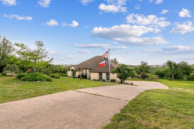 1011 Windmill Rd, Dripping Springs, TX 78620 - view of home's exterior with a yard, a shingled roof, and driveway