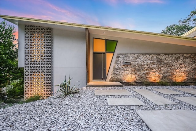 1900 Airole Way, Austin, TX 78704 - exterior entry at dusk with stucco siding