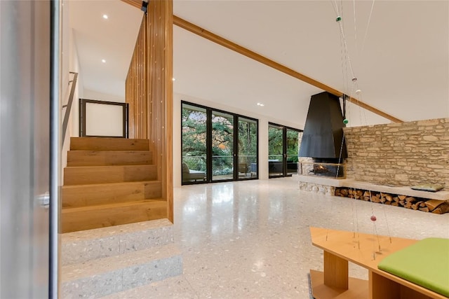 1900 Airole Way, Austin, TX 78704 - stairway with a high ceiling, speckle patterned floor, and a stone fireplace