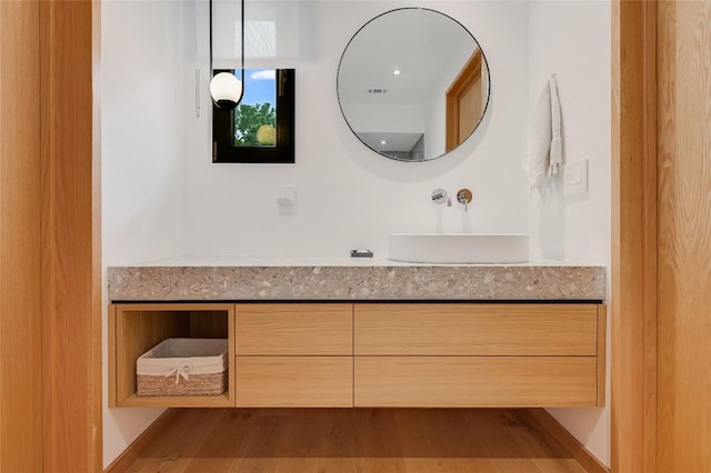 1900 Airole Way, Austin, TX 78704 - bathroom featuring vanity and wood finished floors