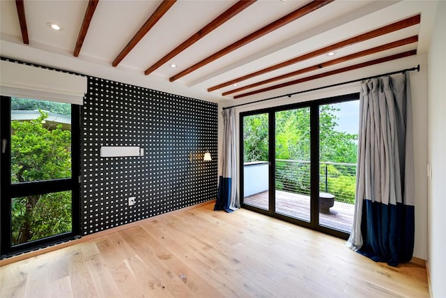 1900 Airole Way, Austin, TX 78704 - unfurnished room with plenty of natural light, wood finished floors, beamed ceiling, and recessed lighting