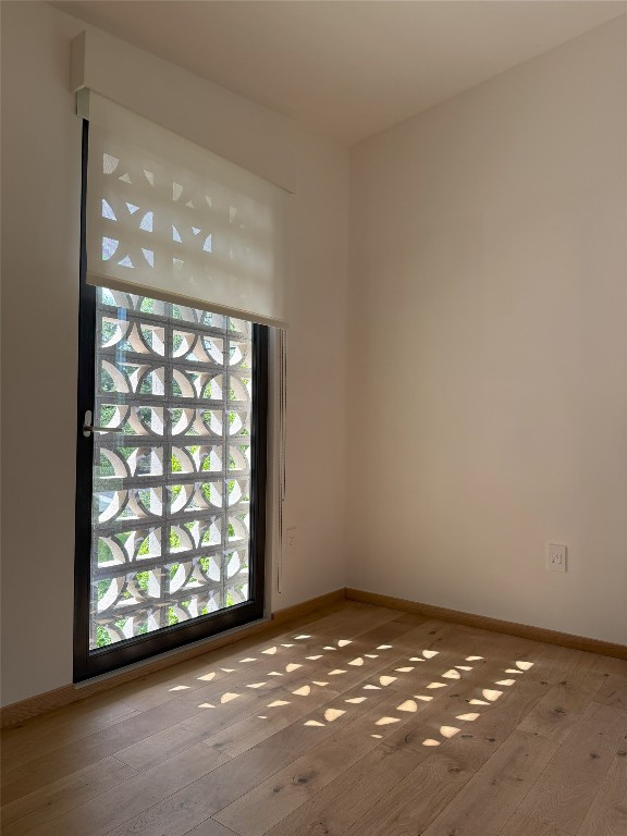 1900 Airole Way, Austin, TX 78704 - unfurnished room with hardwood / wood-style flooring and baseboards
