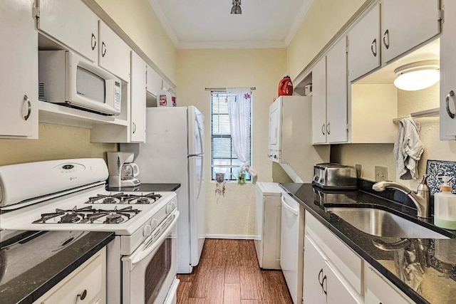 303 W 35th St Unit 202, Austin, TX 78705 - kitchen with white appliances, crown molding, dark wood-type flooring, white cabinetry, and dark stone counters