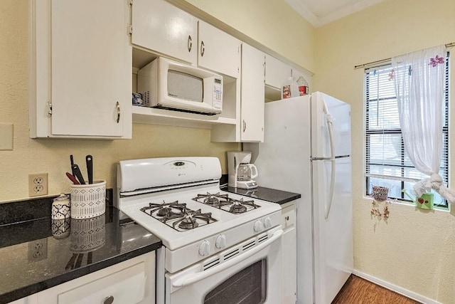 303 W 35th St Unit 202, Austin, TX 78705 - kitchen featuring white appliances, ornamental molding, white cabinets, wood finished floors, and dark stone countertops