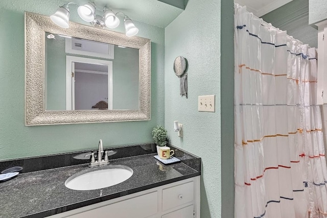 303 W 35th St Unit 202, Austin, TX 78705 - bathroom featuring a textured wall, vanity, and a shower with curtain