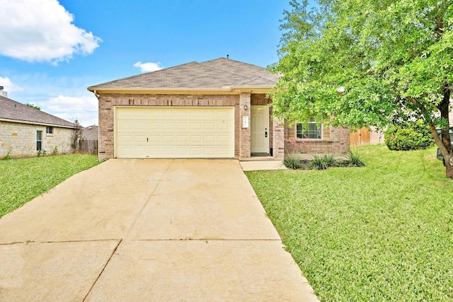 141 Ashwood N, Kyle, TX 78640 - view of front facade featuring brick siding, driveway, a front yard, and an attached garage