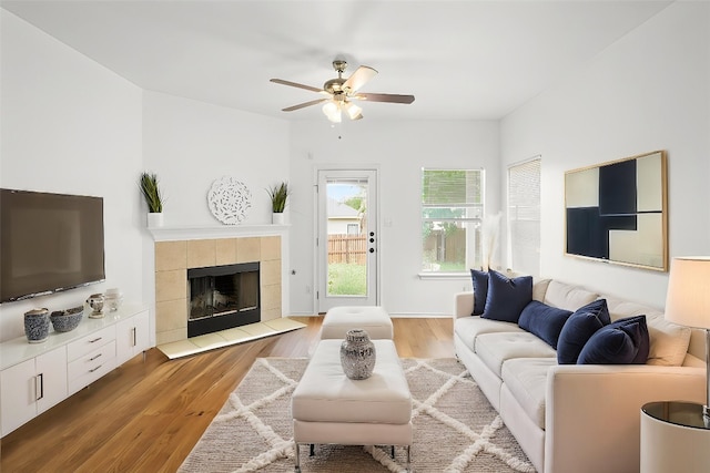 141 Ashwood N, Kyle, TX 78640 - living room featuring ceiling fan, wood finished floors, and a fireplace