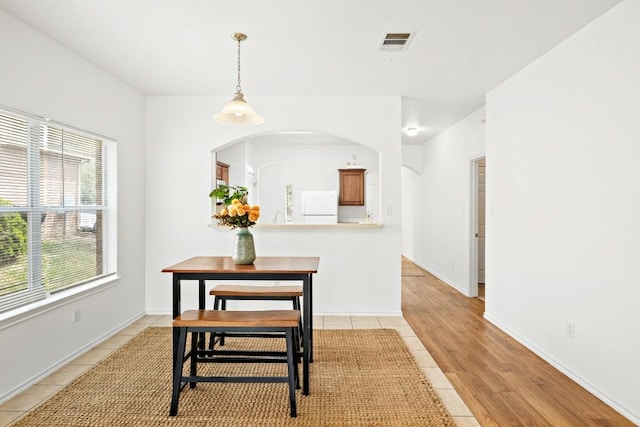 141 Ashwood N, Kyle, TX 78640 - dining room featuring light tile patterned flooring and arched walkways