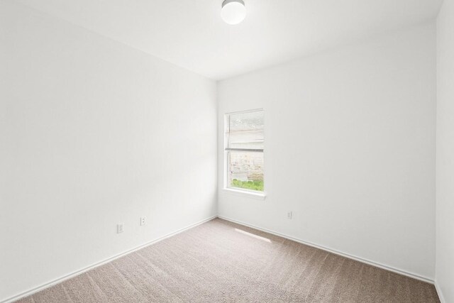 141 Ashwood N, Kyle, TX 78640 - carpeted spare room featuring baseboards